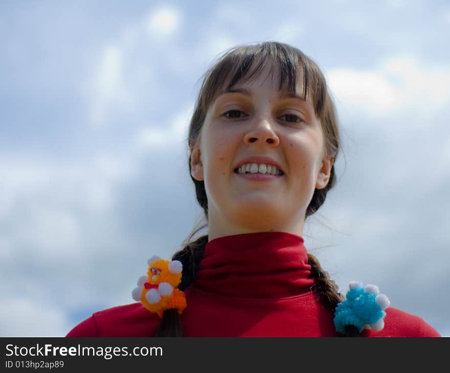 Smiling girl on the sky background