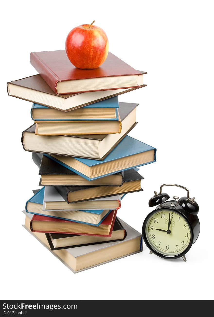 Pile of books, alarm clock and apple isolated on a white background. Concept for Back to school