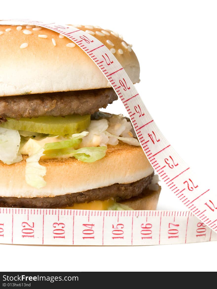 Bread with fried meat, cheese, onion, lettuce and measuring tape isolated on a  white background. Bread with fried meat, cheese, onion, lettuce and measuring tape isolated on a  white background.