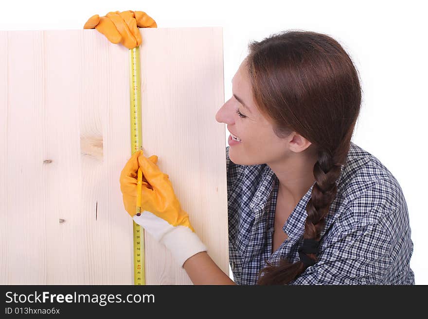 Woman carpenter with wooden plank and measuring tape