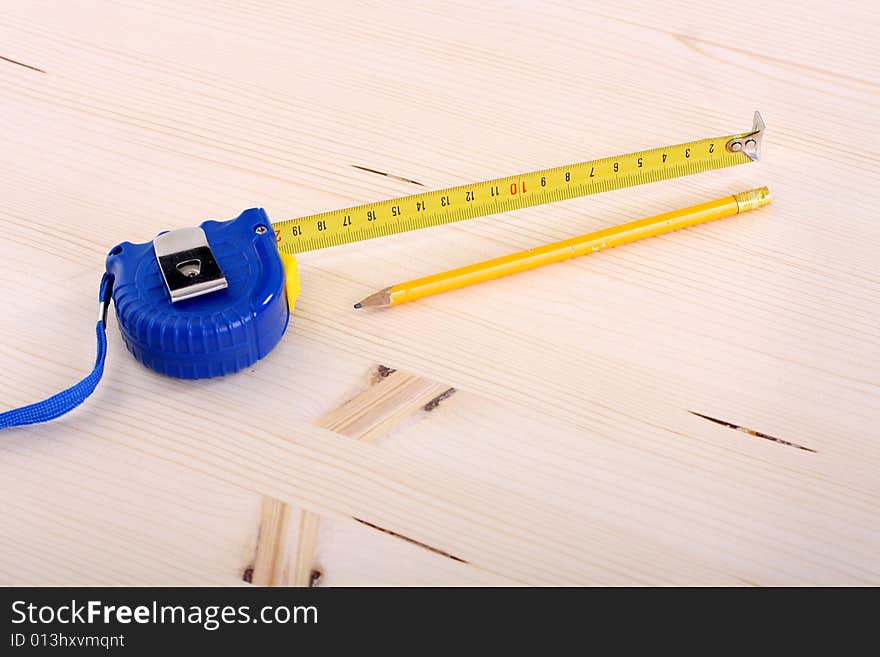 Closeup shot of wooden plank and measuring tape