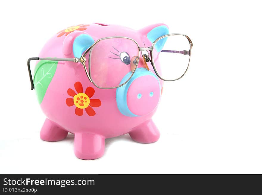 Piggy bank wearing glasses isolated over white. Piggy bank wearing glasses isolated over white