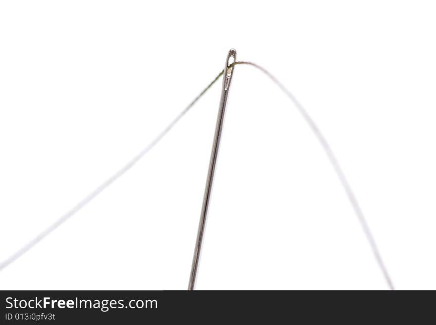 Close up of a needle with thread isolated over white background.