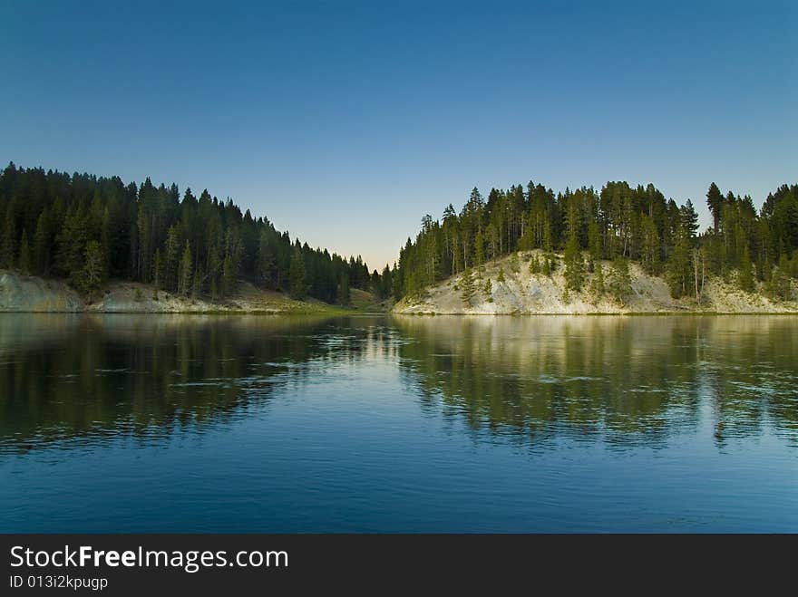 Forest reflecting from the Yellowstone River. Forest reflecting from the Yellowstone River.