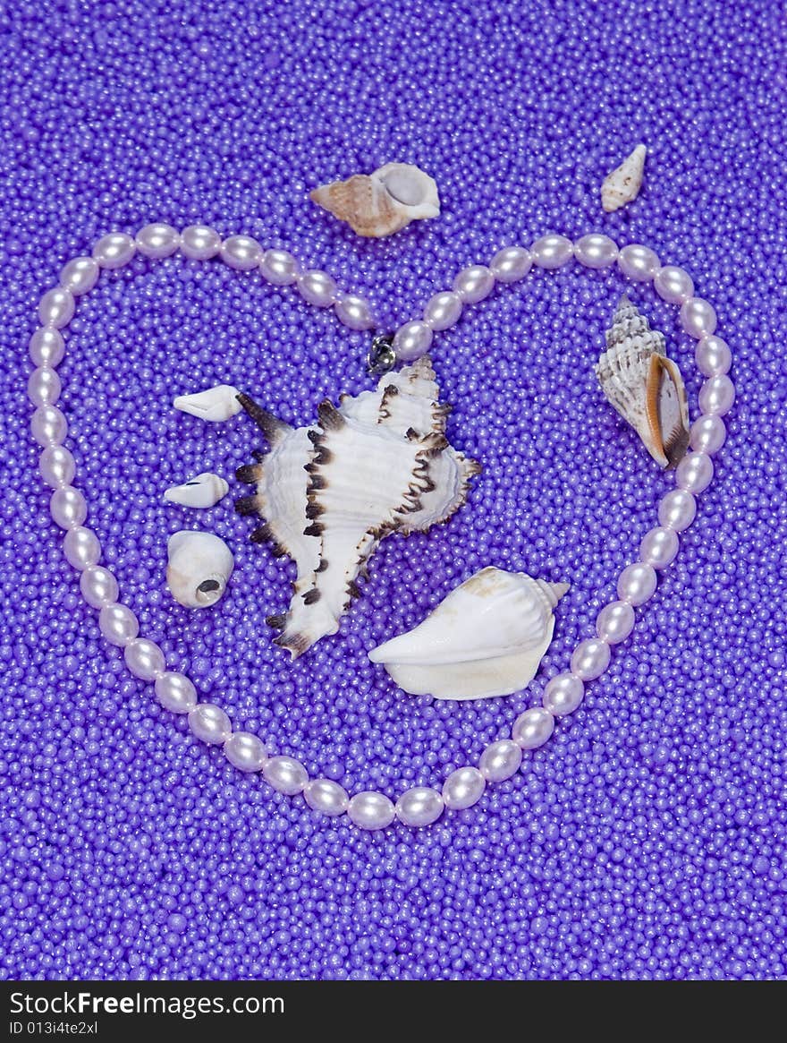 Heart from pearls beads on a lilac background ex