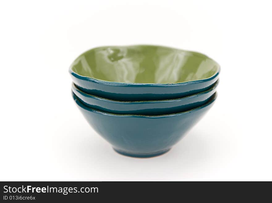 Three turquoise glass bowls on a white backgrounds. Three turquoise glass bowls on a white backgrounds