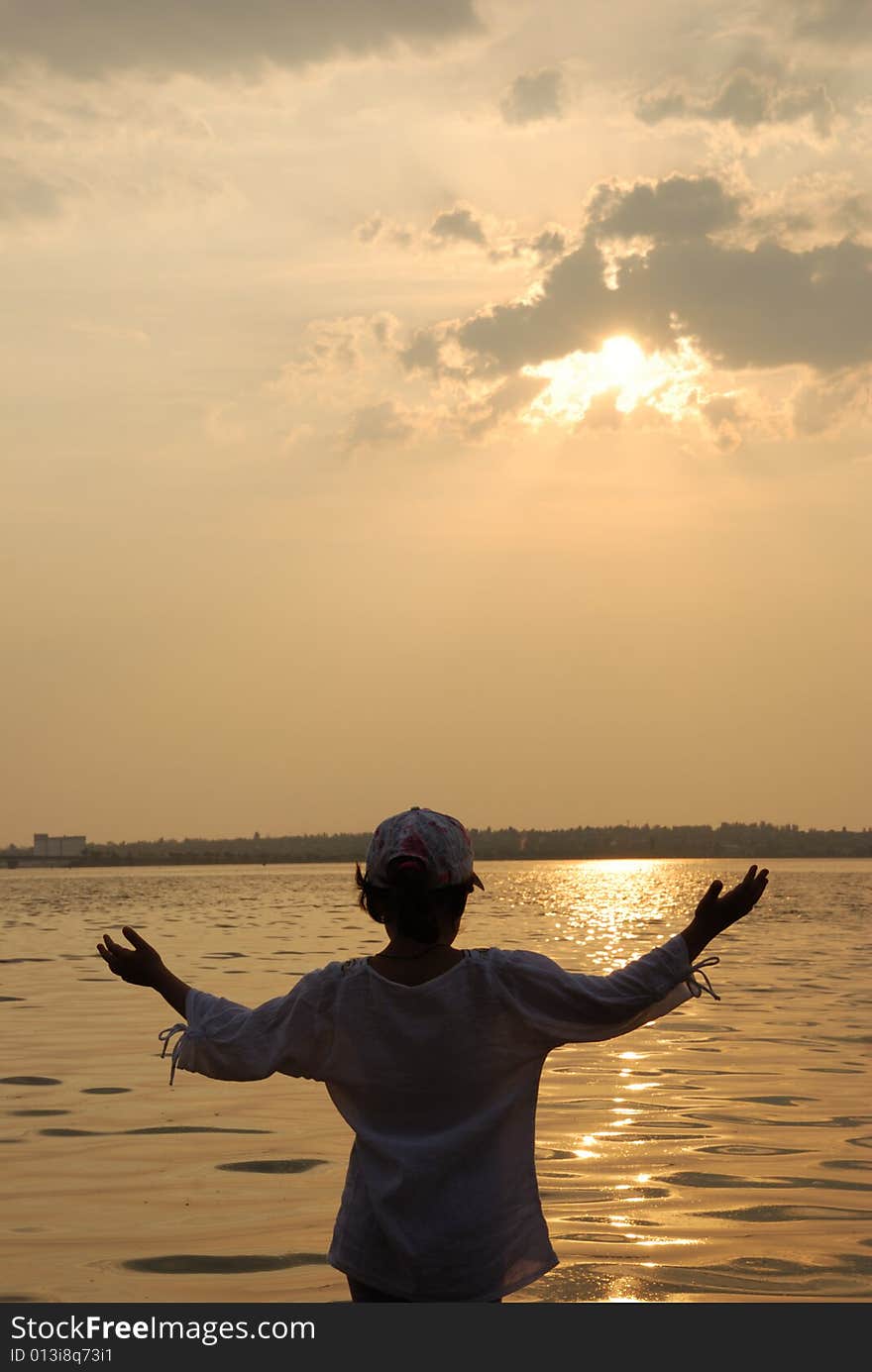 Happy kid on sunset background