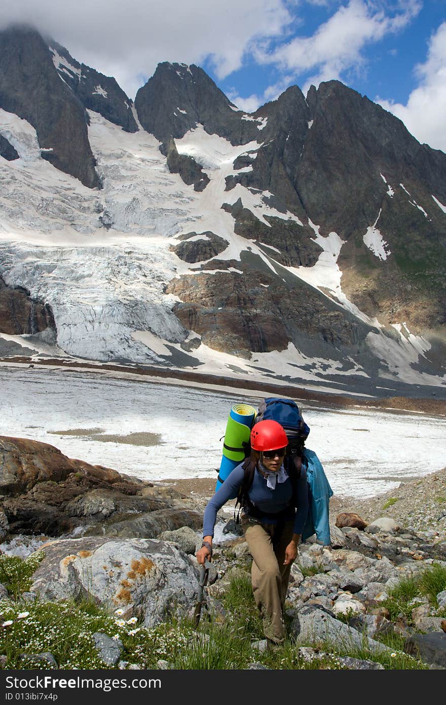 Tourist girl mountaineering on mountain