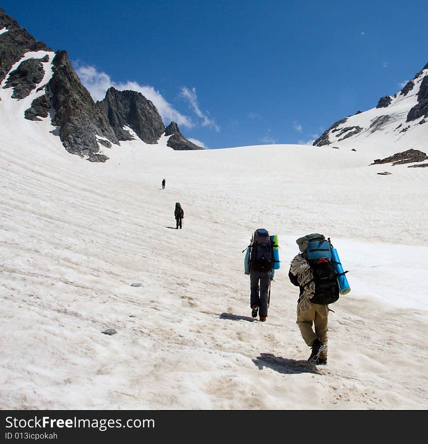 Group of mountain-climber going up to snow pass. Group of mountain-climber going up to snow pass