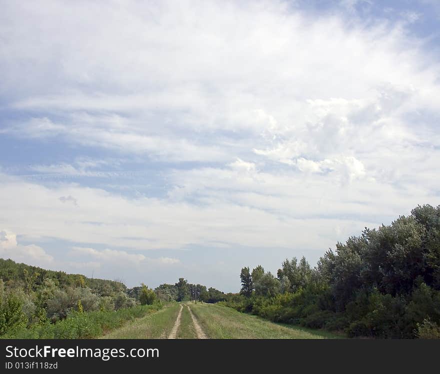 Dirty pathway on meadow and white clouds. Dirty pathway on meadow and white clouds.