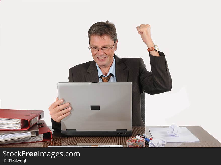 Happy business man, reading good news on his laptop. Happy business man, reading good news on his laptop.