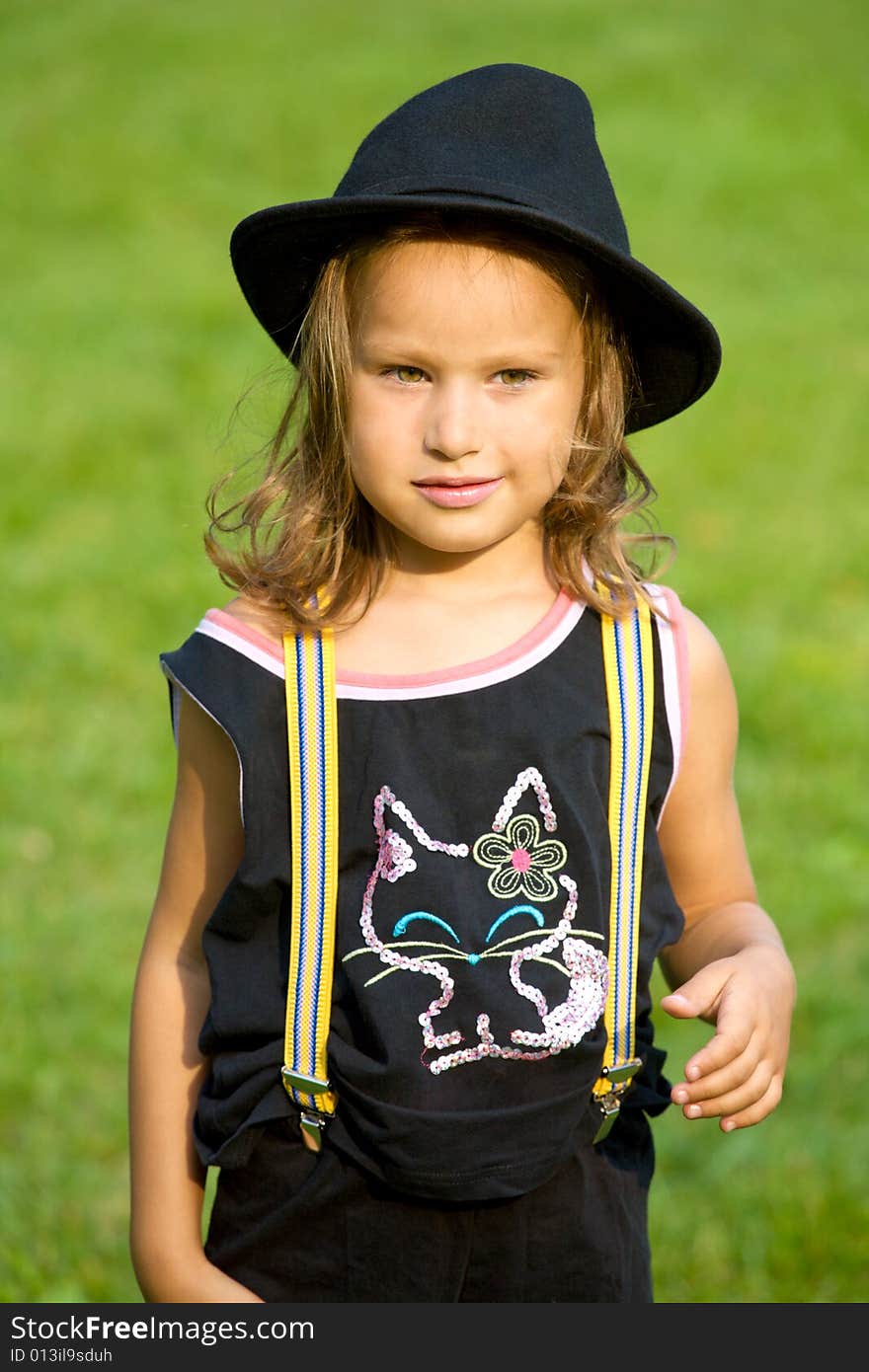 Closeup portrait of little girl on green grass background. Closeup portrait of little girl on green grass background