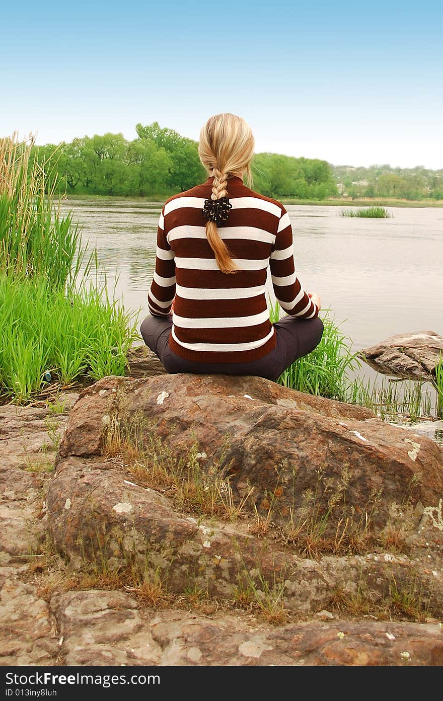 Beautiful girl meditating on a hilltop. Beautiful girl meditating on a hilltop