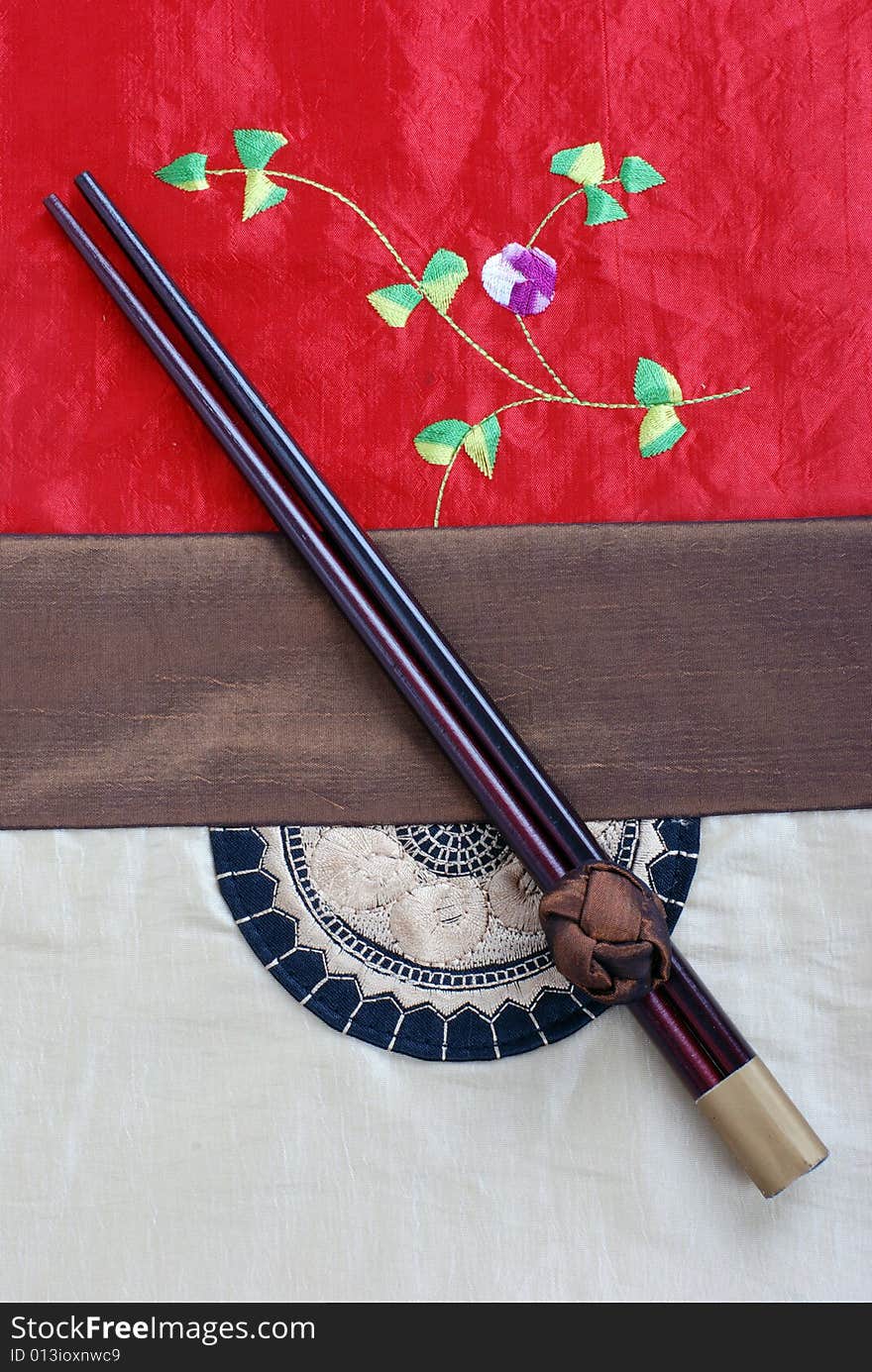 Chopsticks on a Chinese style table cloth. Chopsticks on a Chinese style table cloth