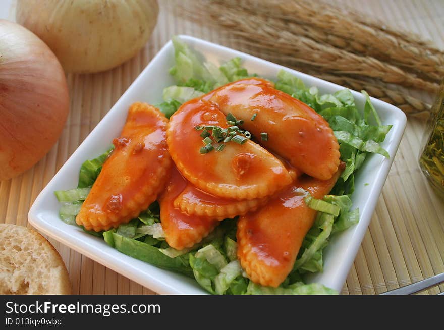 Italian pasta called raviolis on salad