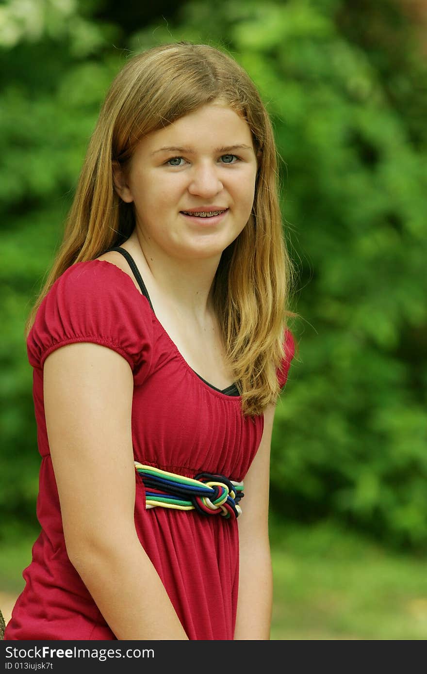 Teenage Girl posing outside in red shirt