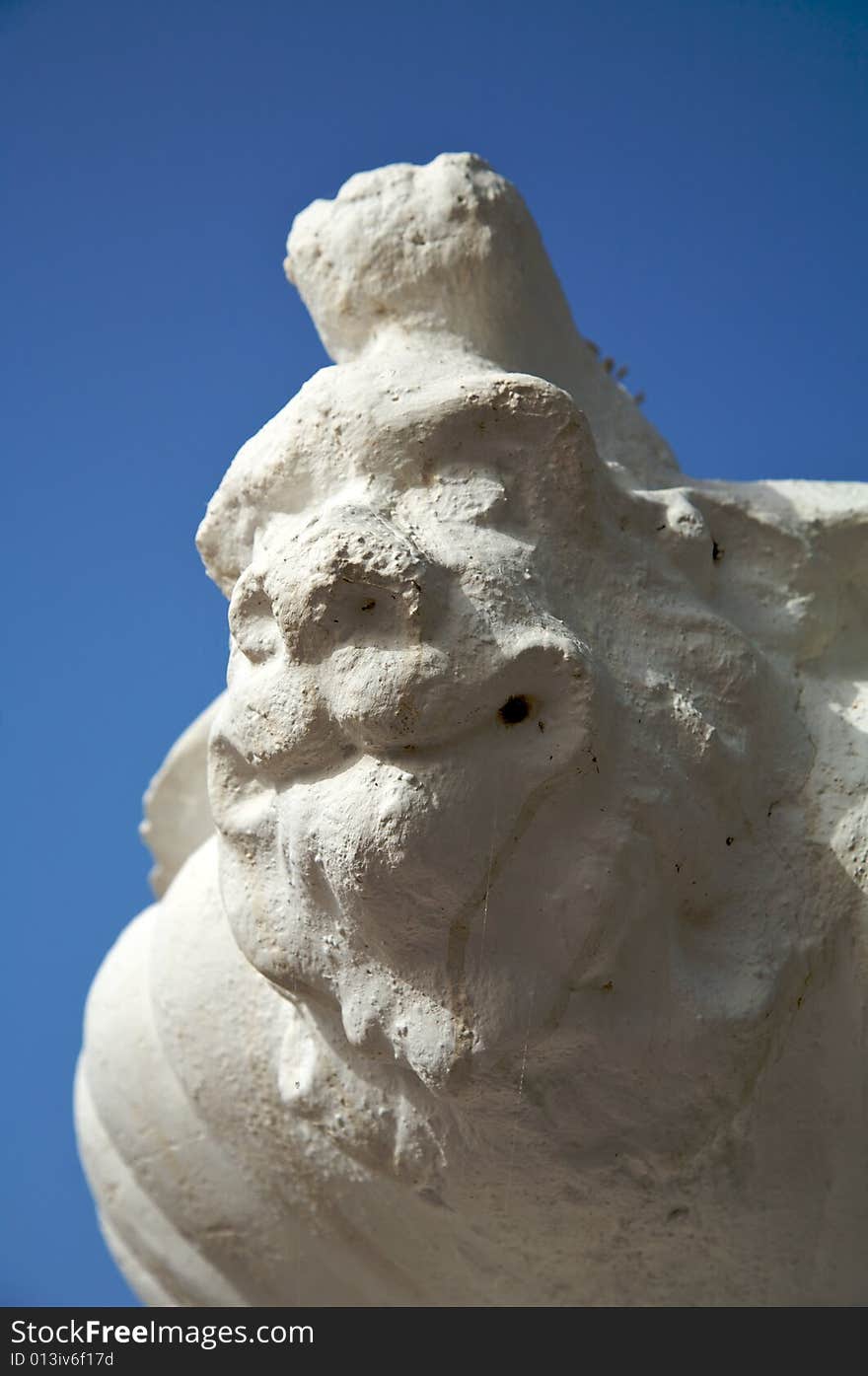 Detail of flowerpot with sculpture face of a devil. Detail of flowerpot with sculpture face of a devil