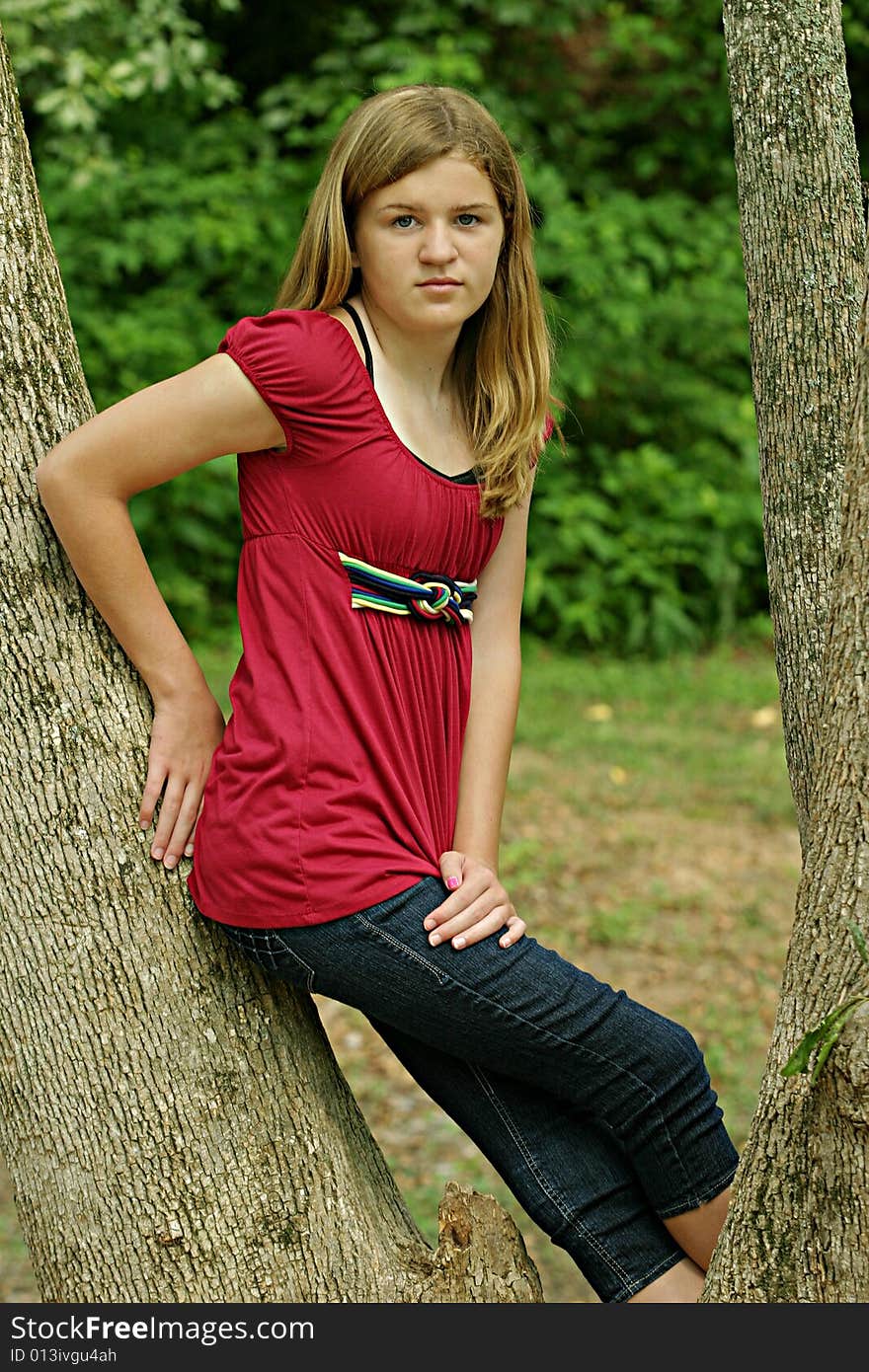 Teenage Girl posing outside in red shirt