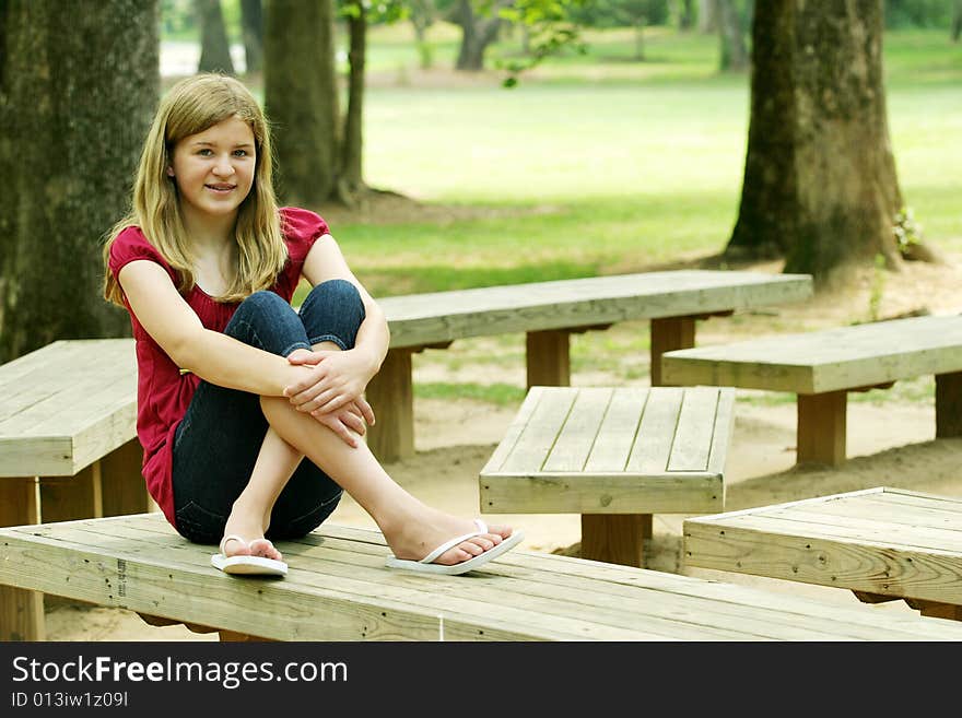 Teenage Girl posing outside in red shirt