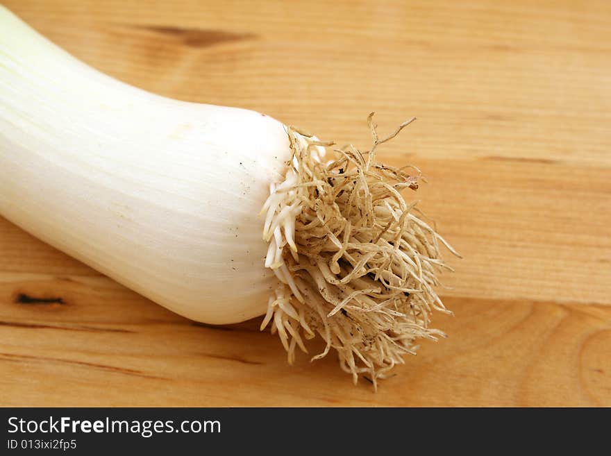 Leek on wooden kitchen board