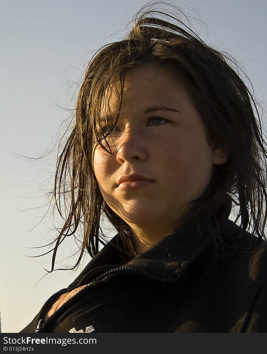 Young Girl/ Teenager half lit face by sunset. Wet hair. Young Girl/ Teenager half lit face by sunset. Wet hair.