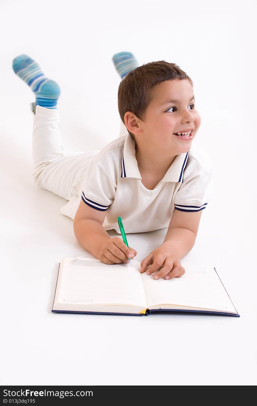 School boy write in note book. School boy write in note book