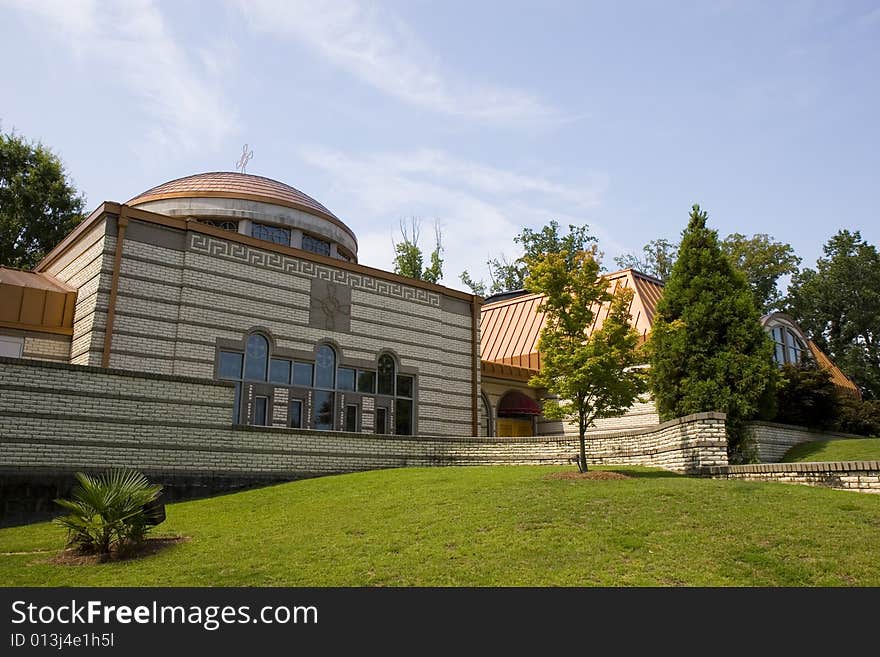 A modern greek orthodox church under blue skies