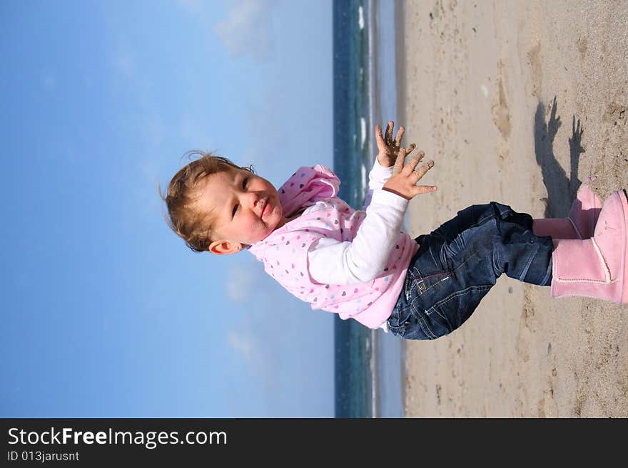 Little girl aged 18 months on the beach exploring the big new world. Little girl aged 18 months on the beach exploring the big new world.