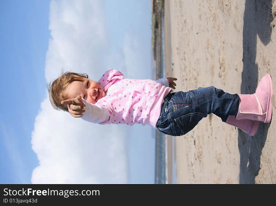 Little girl aged 18 months on the beach exploring the big new world. Little girl aged 18 months on the beach exploring the big new world.