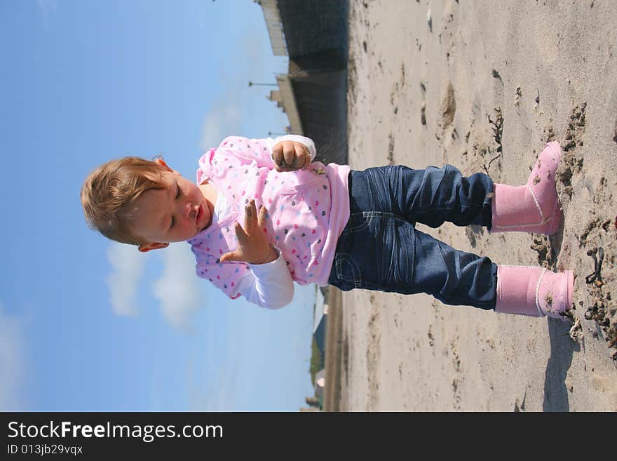 Little girl aged 18 months on the beach exploring the big new world. Little girl aged 18 months on the beach exploring the big new world.