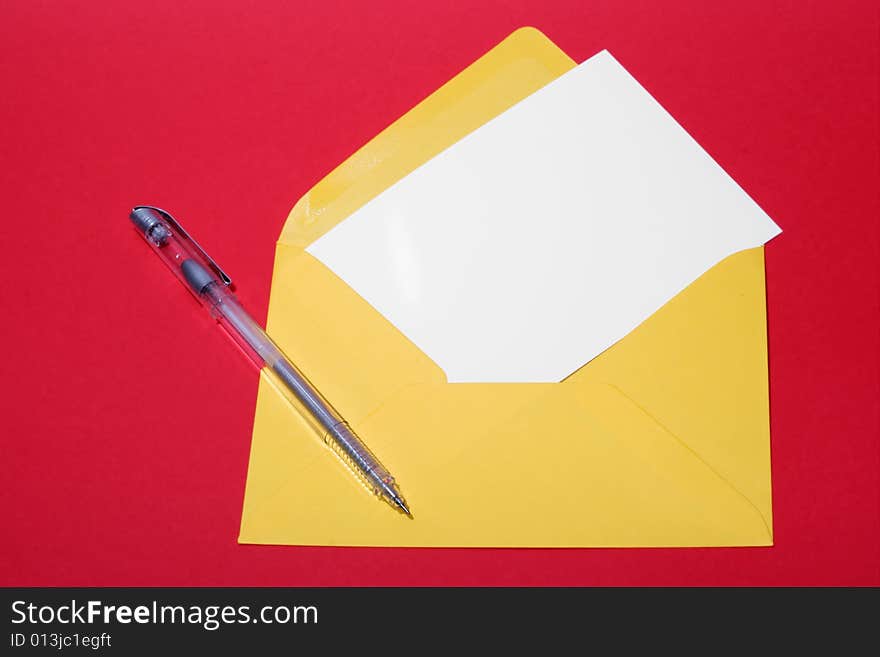 Letter paper and envelope on a red background; empty space for a message.