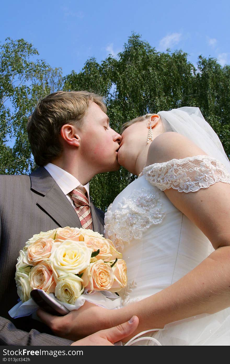 The groom and the bride during walk in park