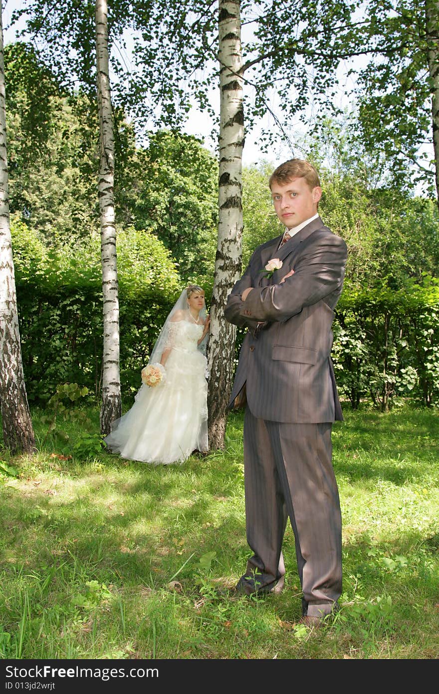 The groom and the bride during walk in park