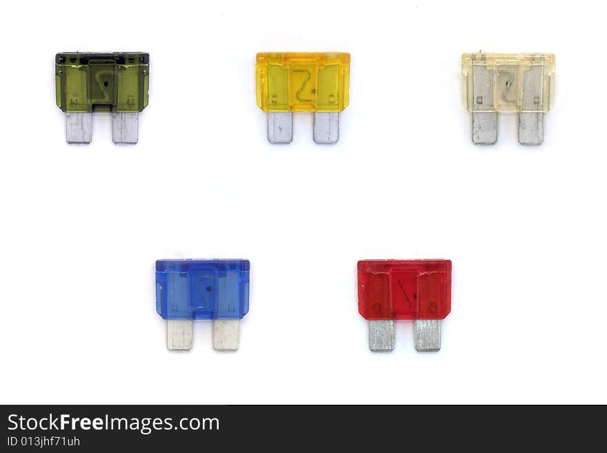 A studio isolated shot of a collection of automobile fuses.