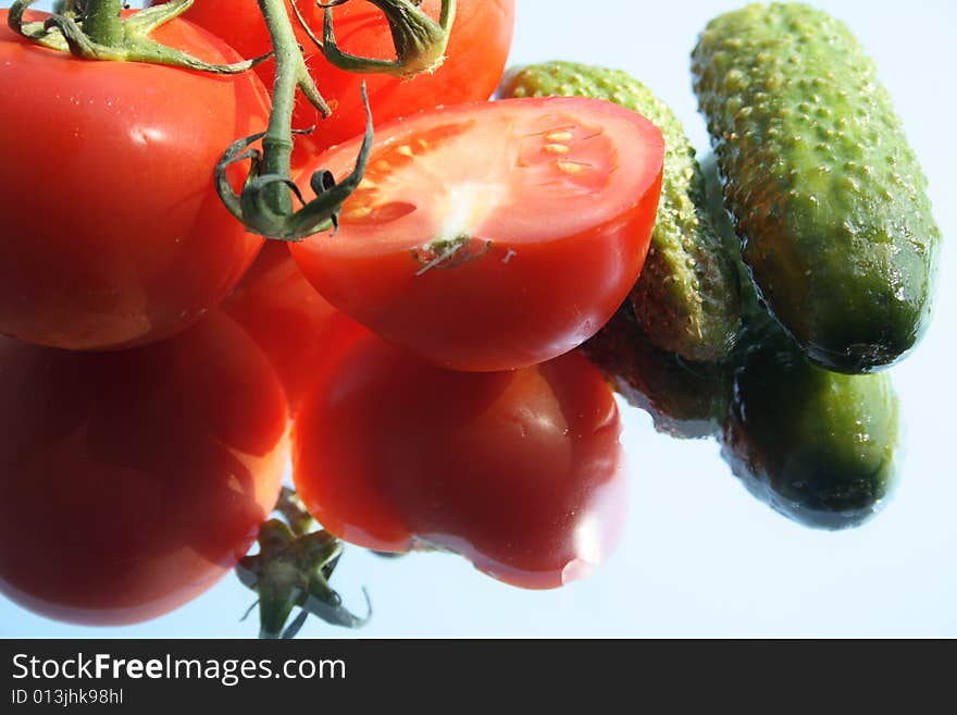 Fresh humid vegetables with reverberation lying on glass. Fresh humid vegetables with reverberation lying on glass