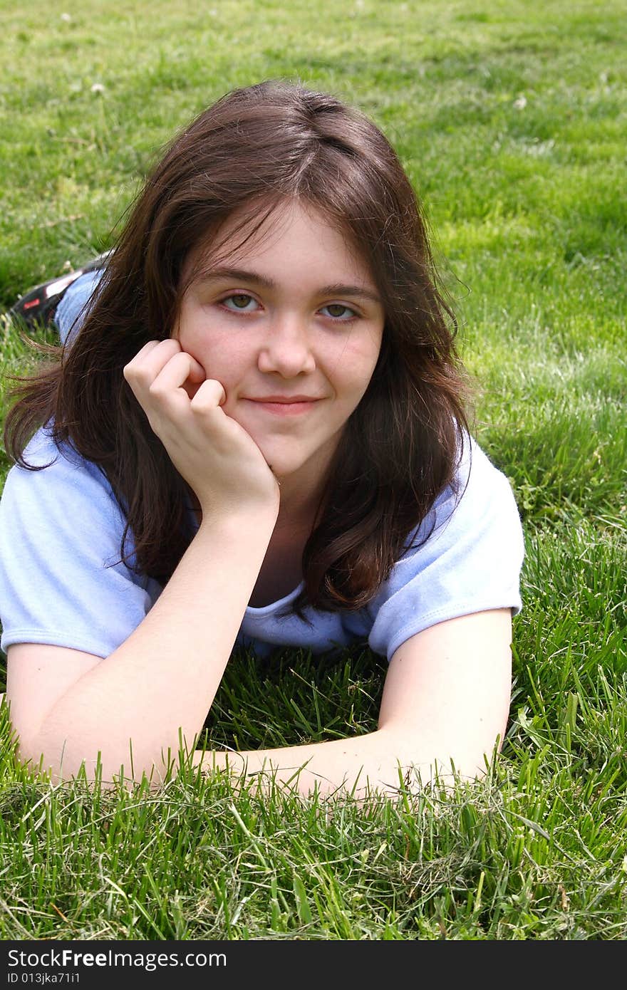 Teen girl in grass smiling