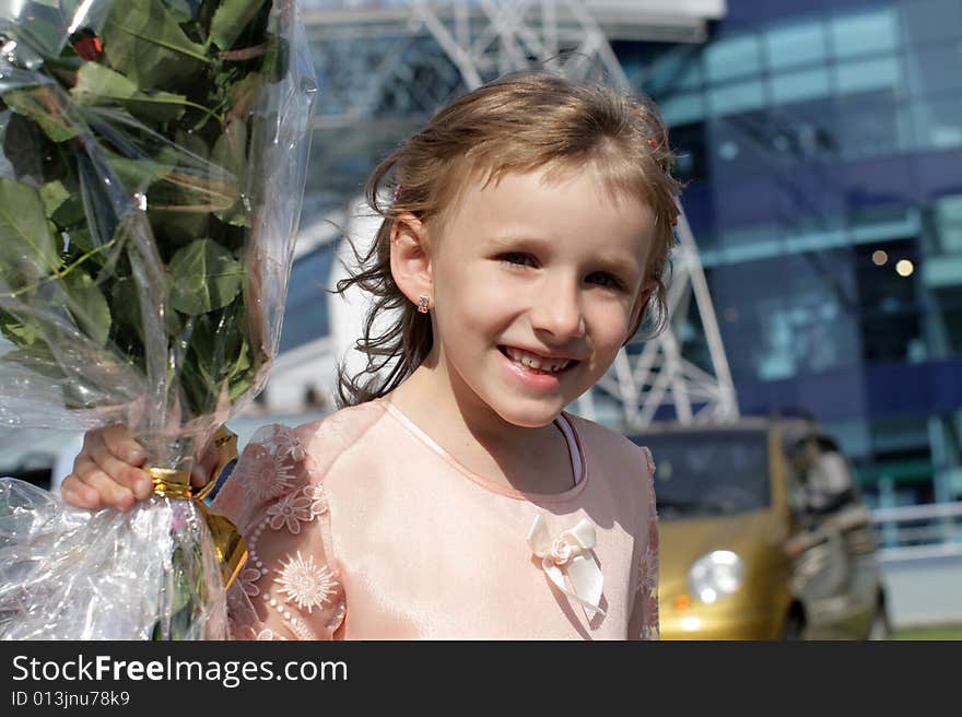 The happy girl with bunch of flowers