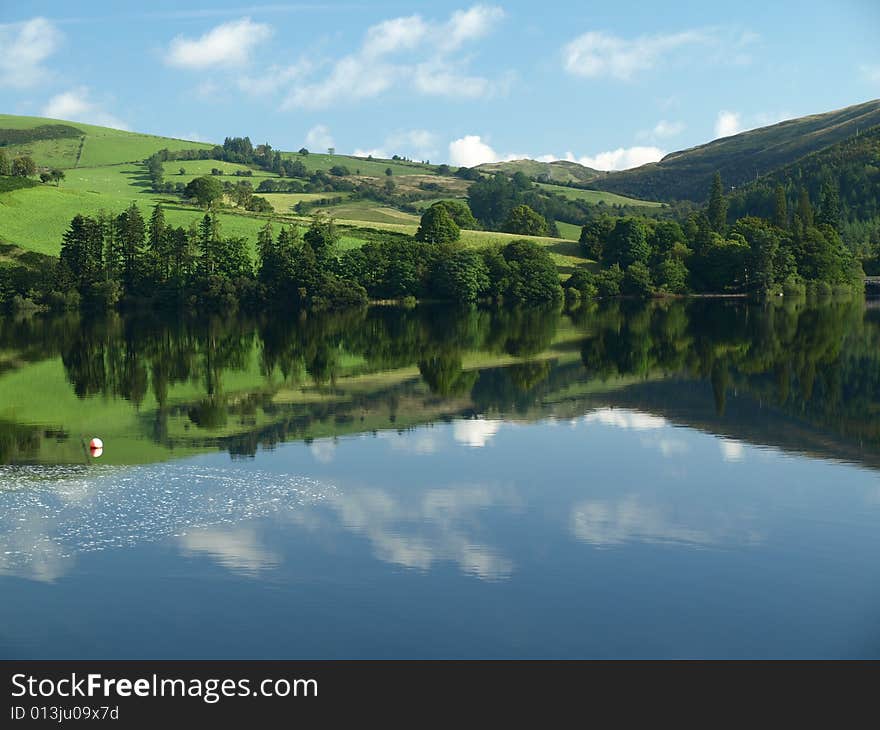 Reflection of fields and medowes on lake vyrnwy