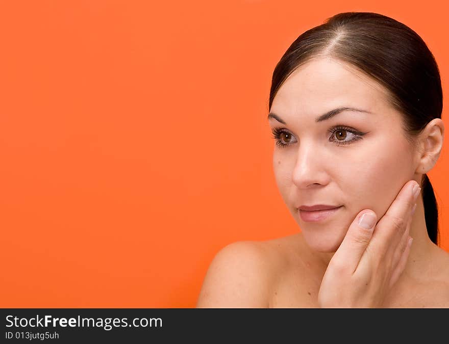 Attractive and fresh brunette woman on orange background. Attractive and fresh brunette woman on orange background