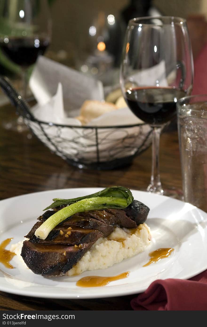 Roasted pork loin over mashed potatoes with red wine