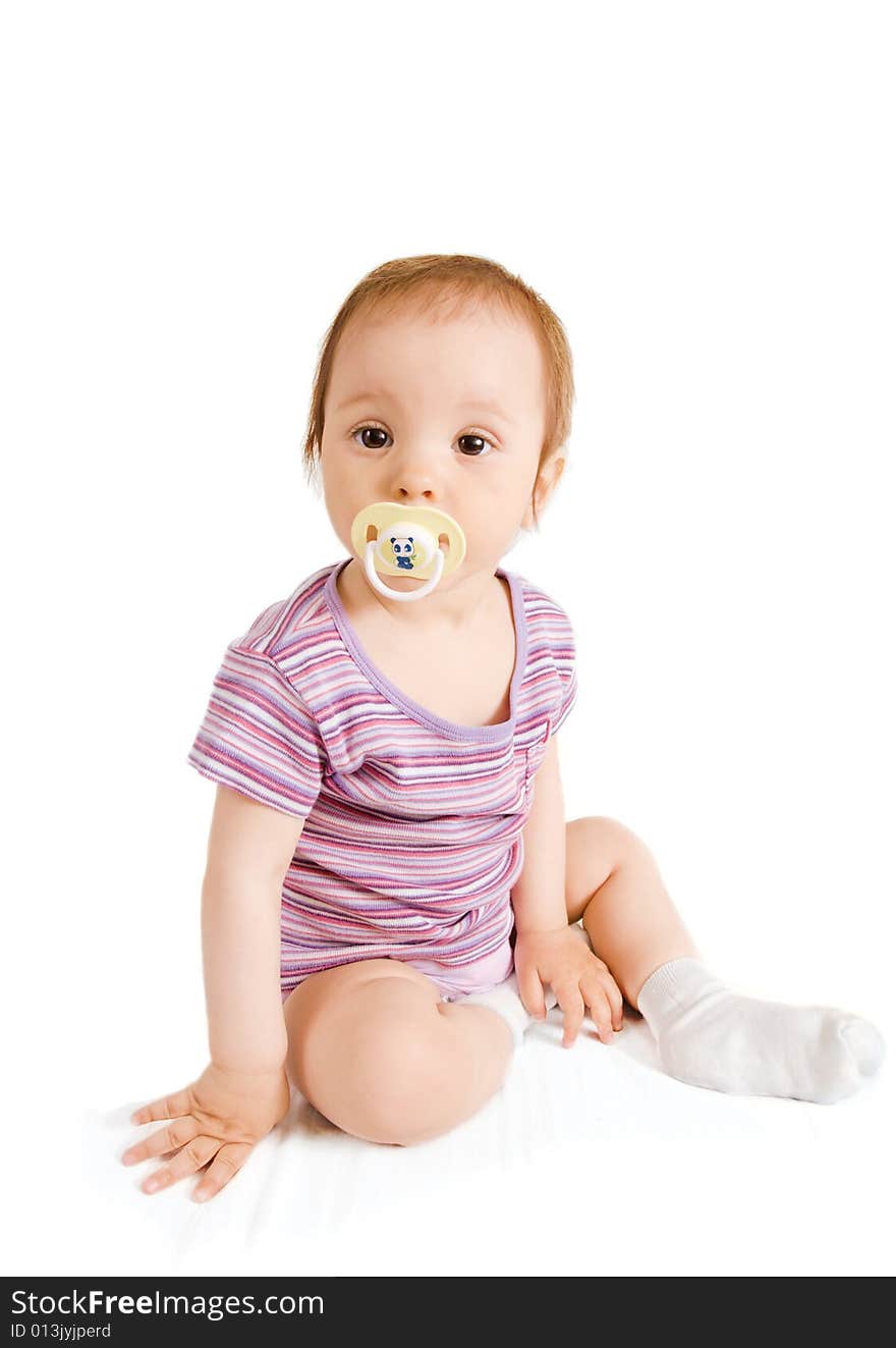 Little girl with pacifier sitting on white background