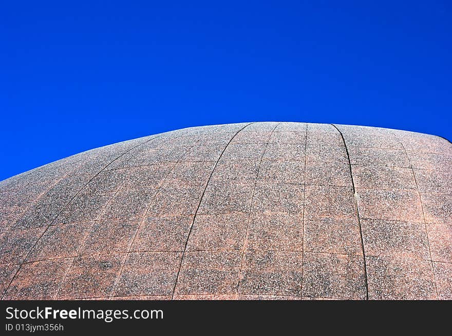 Large cement dome against a deep blue sky. Large cement dome against a deep blue sky