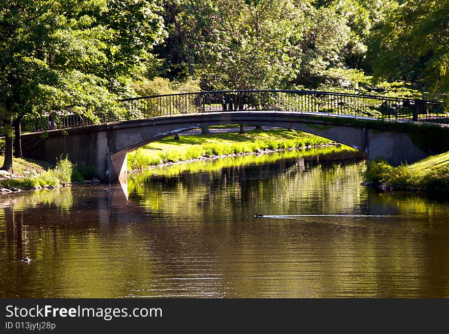 Scenic walking bridge arches over the charles river in boston massachusetts surrounded by trees. Scenic walking bridge arches over the charles river in boston massachusetts surrounded by trees