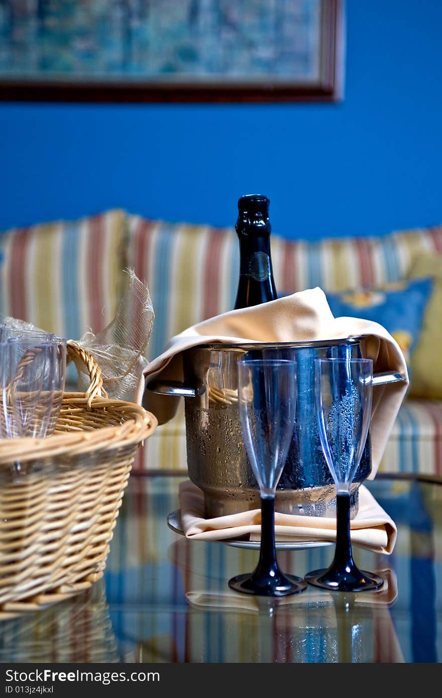 Champagne glasses and bottle in hotel suite for celebration