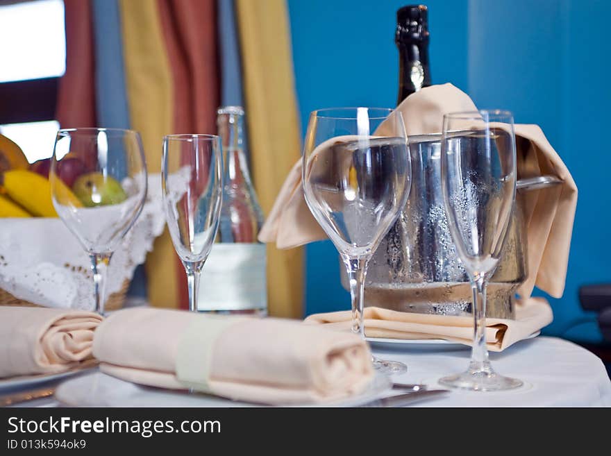 Champagne glasses and bottle in hotel suite for celebration