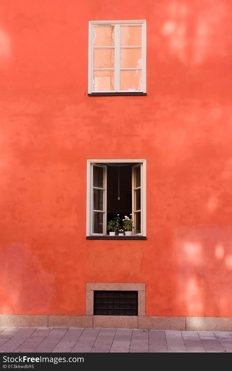 Two windows on an orange wall