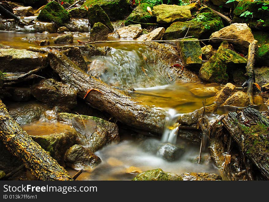 This is s shot of a creek and some rocks and  debris in it.