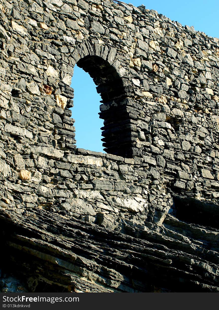 A beautiful shot of an open window in a ancient wall in Porto Venere. A beautiful shot of an open window in a ancient wall in Porto Venere