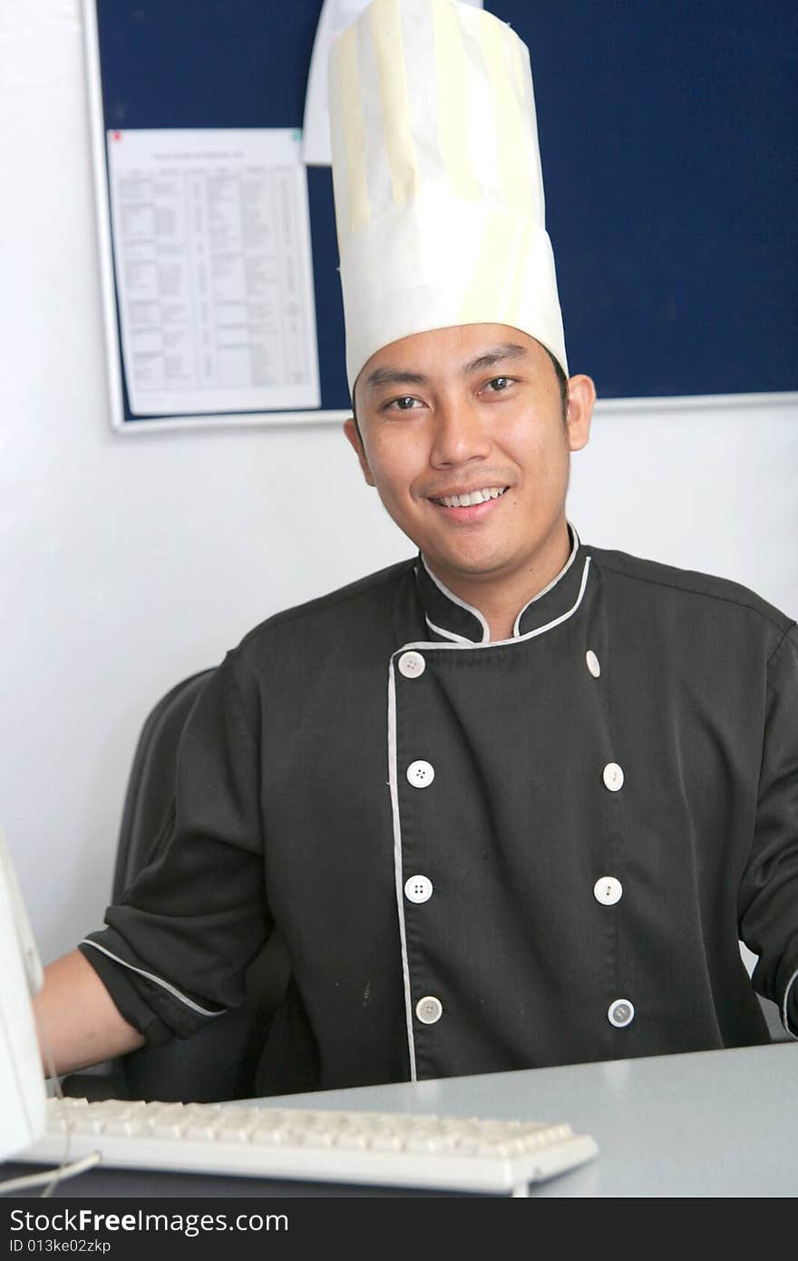 Chef in office with computer