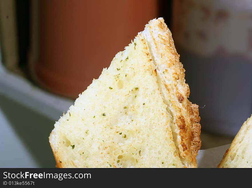 Close up of a single slice of garlic bread